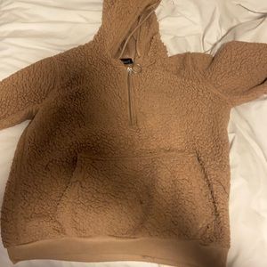This is a teddy bear sweater with a half zipper